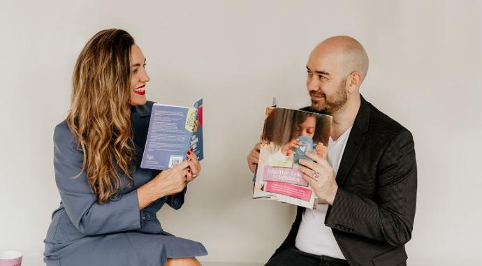 Sandi and Chris Phoenix holding books