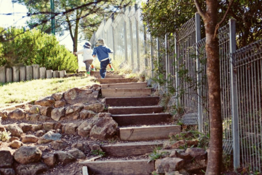 Children walking up a flight of stairs at an early learning service