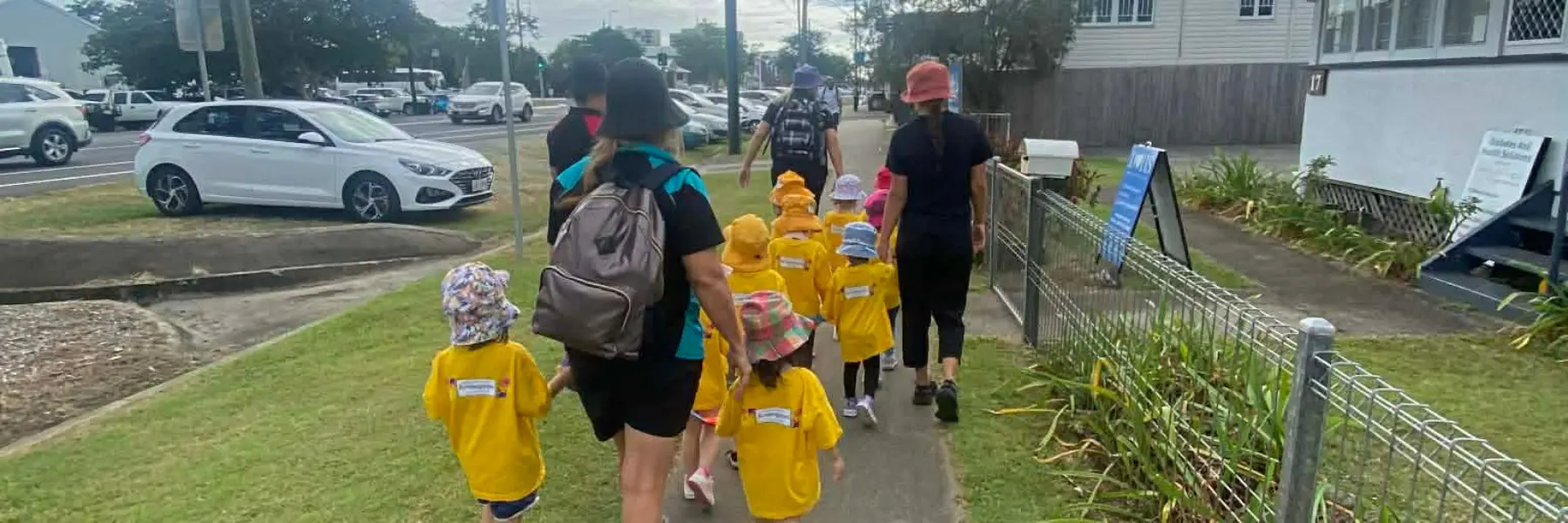 Educators and children from Water St Childcare and Kindergarten in Cairns walking together on an excursion